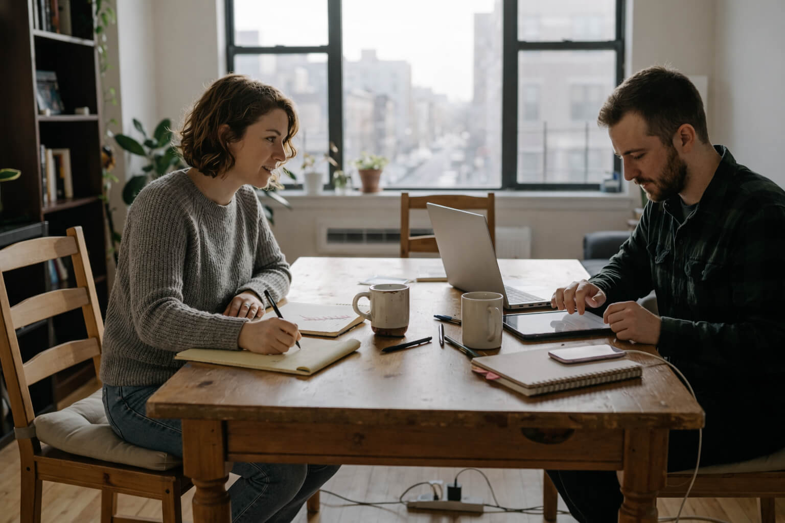 Creative professionals comparing AI tools at home workspace