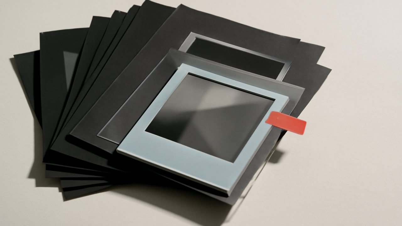Rejected contact sheets surrounding one carefully preserved transformed crop