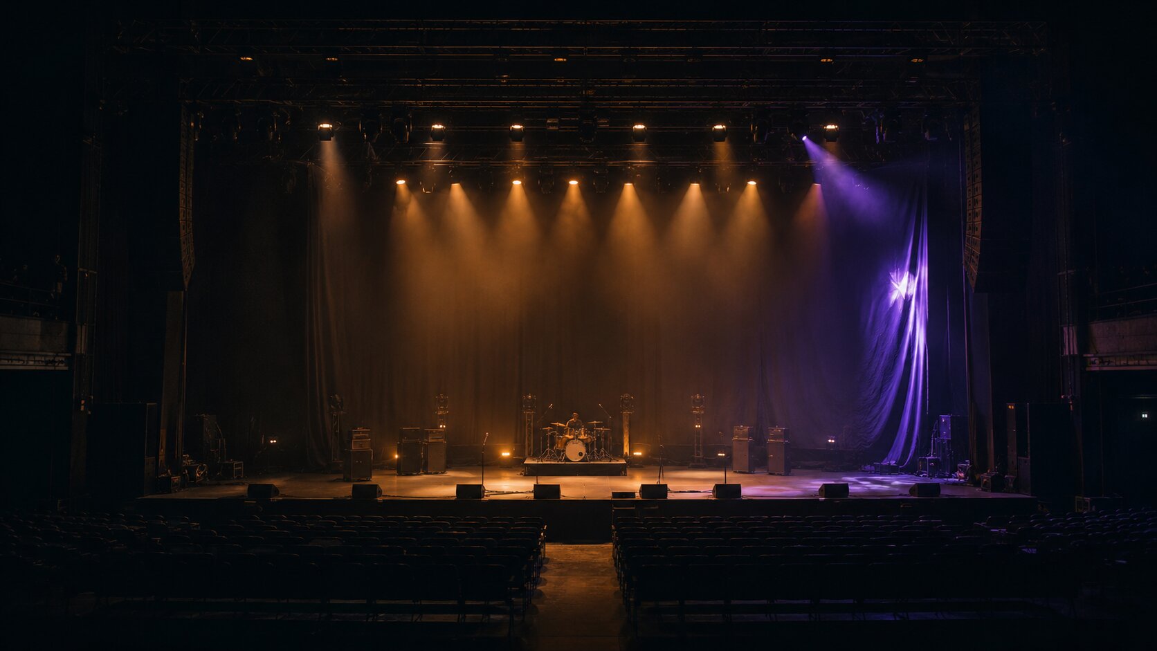 An empty concert stage paused during a final lighting check shows why creative work must be reviewed where the audience will actually experience it.
